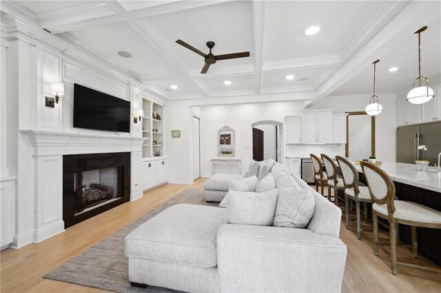 3117 39th St, Metairie, LA 70001 - living area featuring a ceiling fan, arched walkways, a fireplace, beamed ceiling, and coffered ceiling