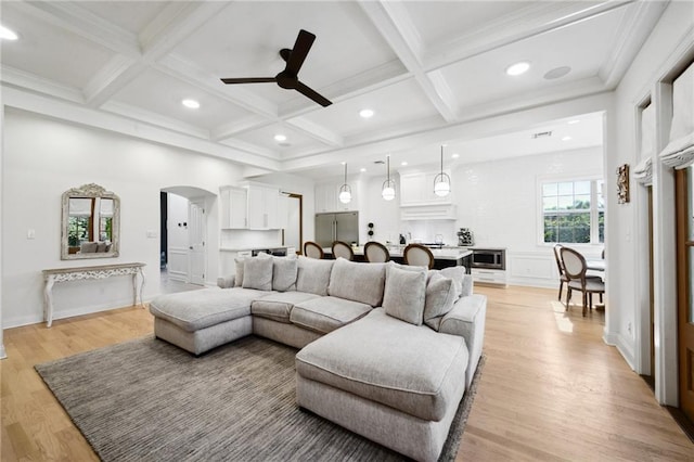 3117 39th St, Metairie, LA 70001 - living area featuring ceiling fan, arched walkways, light wood-style floors, coffered ceiling, and beam ceiling