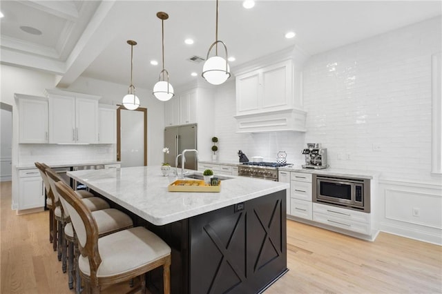 3117 39th St, Metairie, LA 70001 - kitchen featuring appliances with stainless steel finishes, a sink, light wood-type flooring, white cabinetry, and recessed lighting