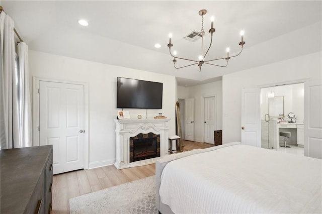 3117 39th St, Metairie, LA 70001 - bedroom with a chandelier, light wood-type flooring, recessed lighting, a fireplace, and baseboards