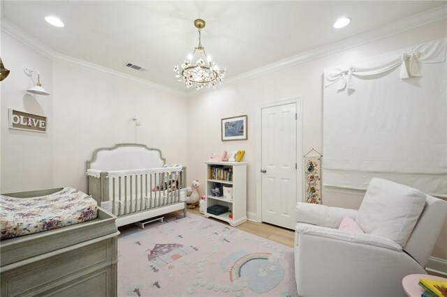 3117 39th St, Metairie, LA 70001 - bedroom featuring wood finished floors, a chandelier, crown molding, a crib, and recessed lighting