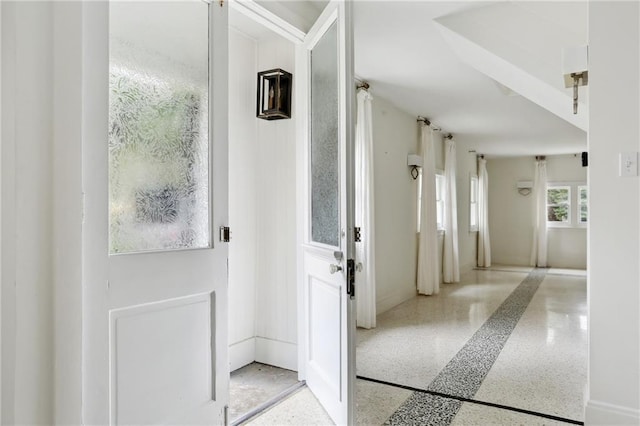 1729 Prytania St, New Orleans, LA 70130 - doorway to outside featuring speckle patterned floor and baseboards