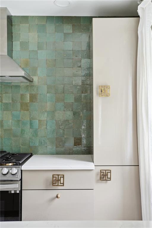 1729 Prytania St, New Orleans, LA 70130 - kitchen view of wall chimney range hood, stainless steel gas range oven, and light countertops