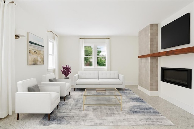 1729 Prytania St, New Orleans, LA 70130 - living area featuring baseboards, a fireplace, and speckle patterned floor