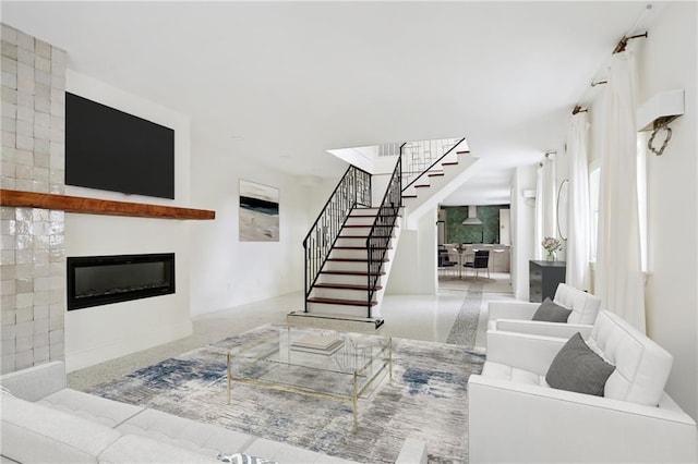 1729 Prytania St, New Orleans, LA 70130 - living room with stairs, a glass covered fireplace, and speckle patterned floor
