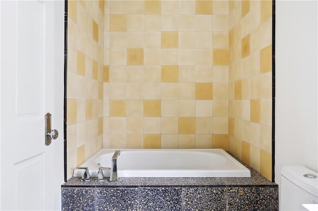 1729 Prytania St, New Orleans, LA 70130 - bathroom featuring a garden tub and toilet