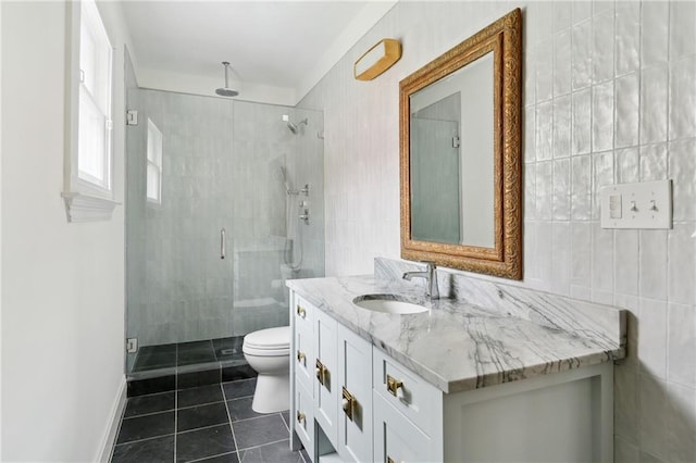 1729 Prytania St, New Orleans, LA 70130 - full bathroom with tile patterned flooring, a stall shower, vanity, toilet, and tile walls