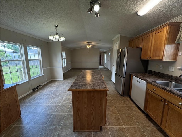 150 Elm St, Hahnville, LA 70057 - kitchen with white dishwasher, dark countertops, a sink, crown molding, and a center island