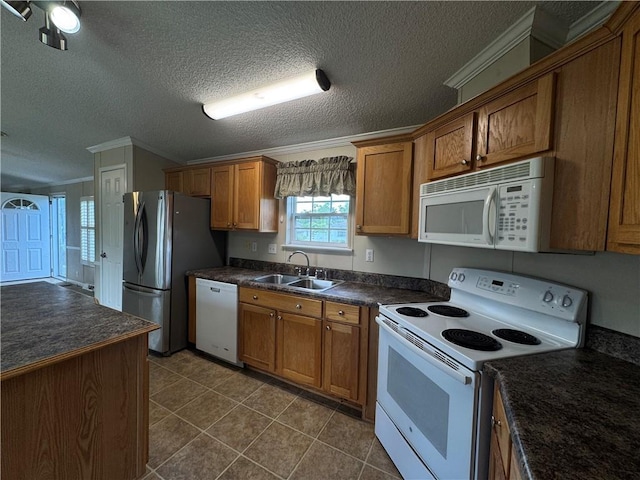 150 Elm St, Hahnville, LA 70057 - kitchen featuring white appliances, a sink, dark countertops, brown cabinetry, and crown molding