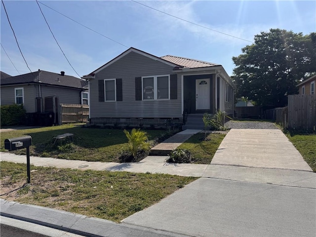 5320 Wickfield Dr, New Orleans, LA 70122 - view of front facade with metal roof and driveway