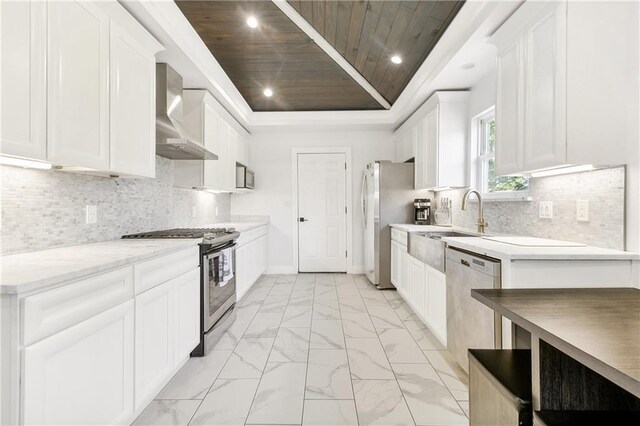 5320 Wickfield Dr, New Orleans, LA 70122 - kitchen featuring appliances with stainless steel finishes, wall chimney exhaust hood, wooden ceiling, light marble finish flooring, and a raised ceiling