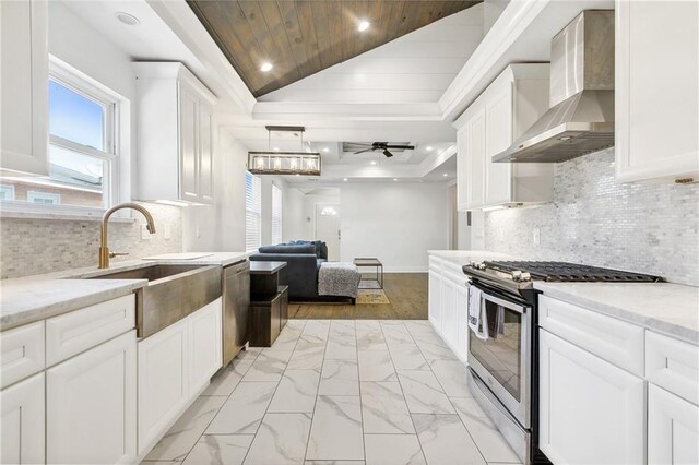 5320 Wickfield Dr, New Orleans, LA 70122 - kitchen with stainless steel appliances, wall chimney range hood, a sink, wood ceiling, and white cabinets
