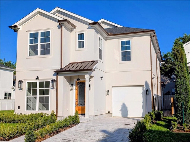 11 Cocos St, Kenner, LA 70065 - view of front of home with a garage, a standing seam roof, stucco siding, decorative driveway, and metal roof