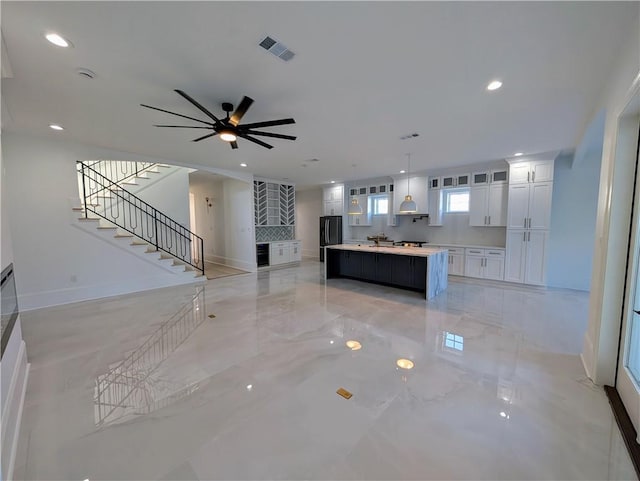 11 Cocos St, Kenner, LA 70065 - unfurnished living room featuring stairs, recessed lighting, baseboards, ceiling fan, and light marble finish flooring