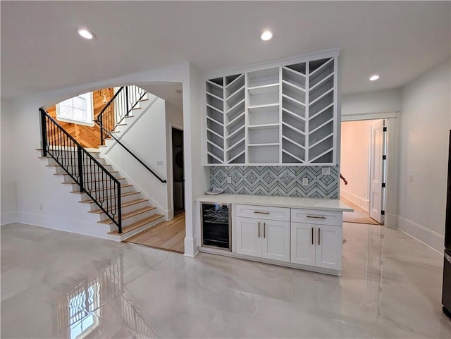 11 Cocos St, Kenner, LA 70065 - hallway with beverage cooler, recessed lighting, baseboards, stairs, and arched walkways