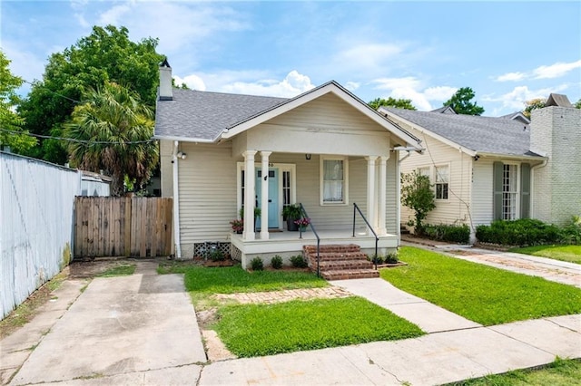 5820 Magnolia St, New Orleans, LA 70115 - bungalow with covered porch, a chimney, and a shingled roof