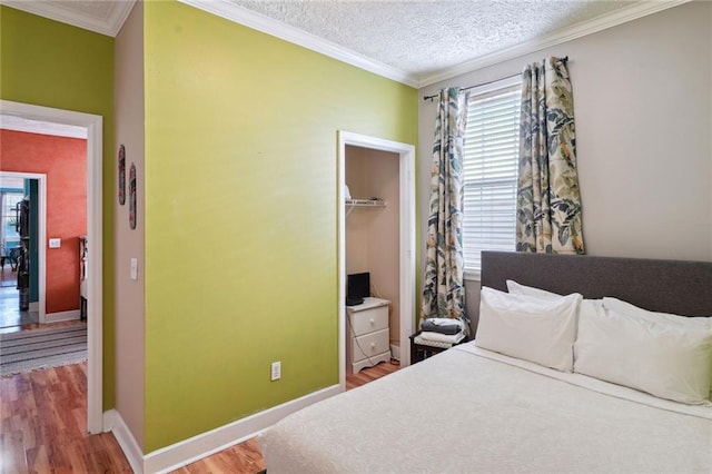 3115 Conti St, New Orleans, LA 70119 - bedroom featuring wood finished floors, multiple windows, ornamental molding, baseboards, and a textured ceiling