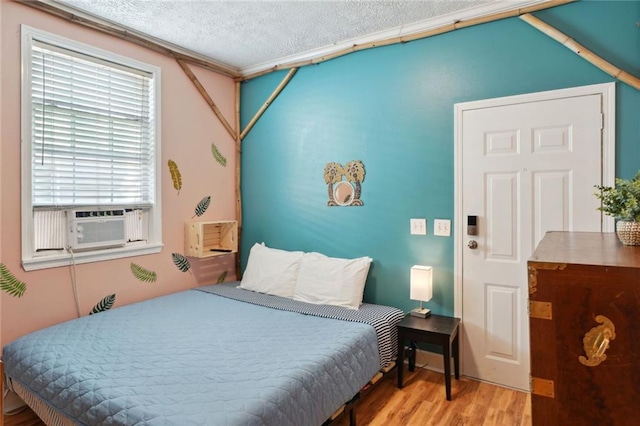 3115 Conti St, New Orleans, LA 70119 - bedroom with wood finished floors, a textured ceiling, and cooling unit