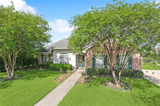 101 Portrush Dr, La Place, LA 70068 - view of front of property with a front lawn, stucco siding, and a shingled roof