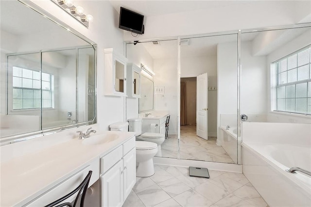 101 Portrush Dr, La Place, LA 70068 - full bathroom featuring marble finish flooring, toilet, a garden tub, and vanity