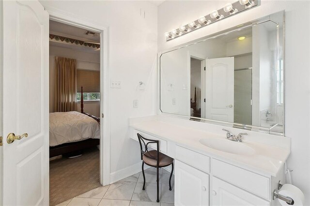 101 Portrush Dr, La Place, LA 70068 - ensuite bathroom featuring vanity, baseboards, a shower with door, and marble look tile flooring