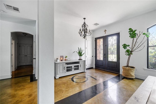 entryway with arched walkways and baseboards