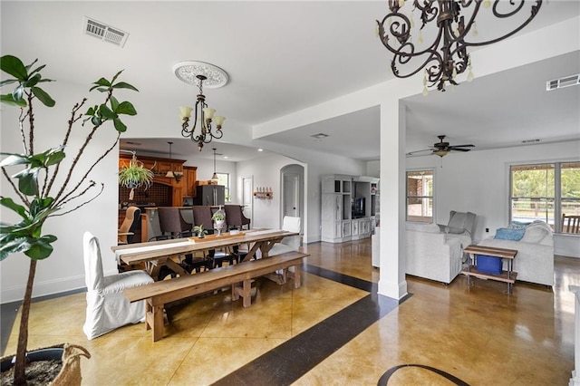 dining room with a chandelier, arched walkways, baseboards, and a ceiling fan