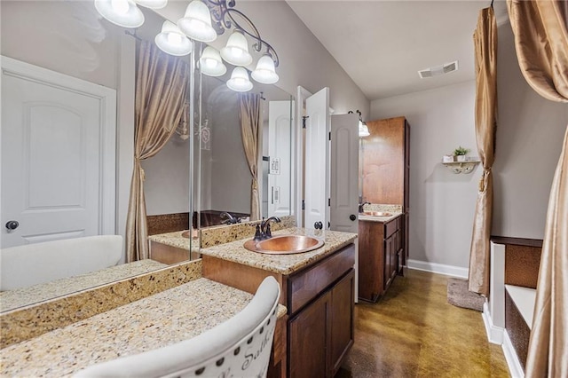 full bath featuring finished concrete flooring, vanity, and baseboards