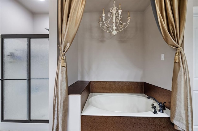 full bath with a chandelier, a garden tub, and a shower
