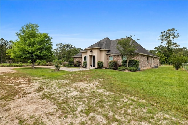 french country style house featuring a front lawn