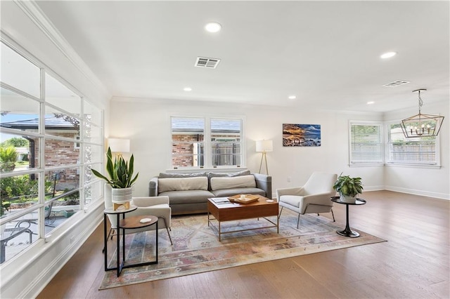 7449 Cameo St, New Orleans, LA 70124 - living area with plenty of natural light, wood finished floors, crown molding, baseboards, and recessed lighting