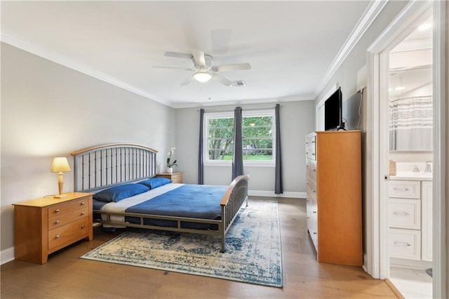 7449 Cameo St, New Orleans, LA 70124 - bedroom featuring light wood finished floors, crown molding, ensuite bathroom, baseboards, and ceiling fan
