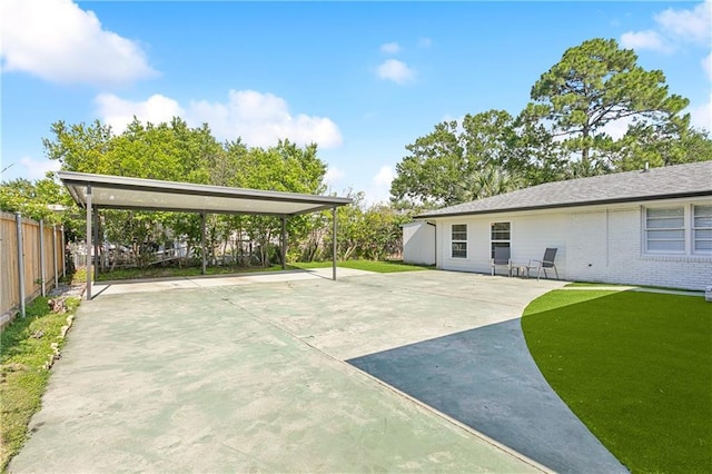 7449 Cameo St, New Orleans, LA 70124 - fenced yard with driveway and a detached carport