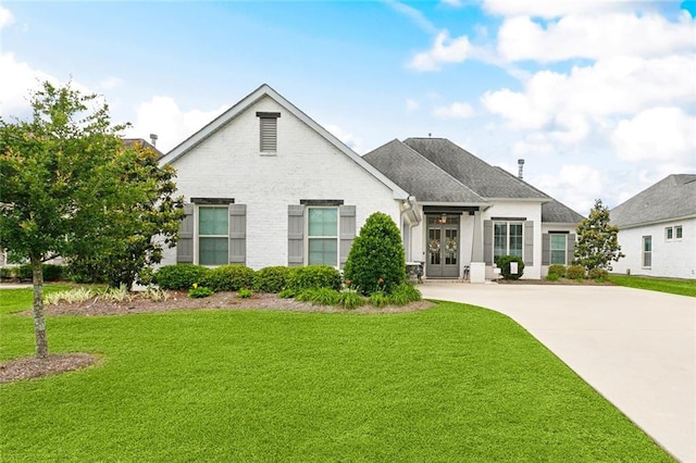 2040 Cypress Bend Ln, Madisonville, LA 70447 - view of front facade with a front lawn, roof with shingles, and driveway
