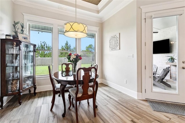 2040 Cypress Bend Ln, Madisonville, LA 70447 - dining space with wood finished floors, baseboards, healthy amount of natural light, crown molding, and a raised ceiling