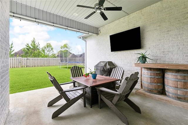 2040 Cypress Bend Ln, Madisonville, LA 70447 - view of patio / terrace featuring a trampoline, a ceiling fan, outdoor dining area, and a grill