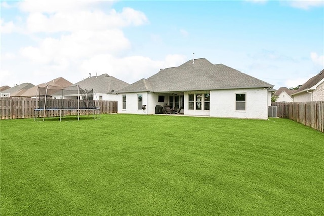 2040 Cypress Bend Ln, Madisonville, LA 70447 - back of house featuring a trampoline, roof with shingles, a patio, and stucco siding