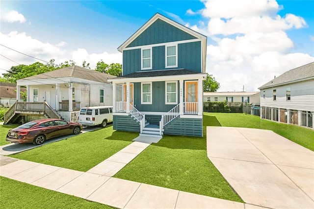 2830-32 Spain St, New Orleans, LA 70122 - traditional style home featuring covered porch, a front lawn, and stairs