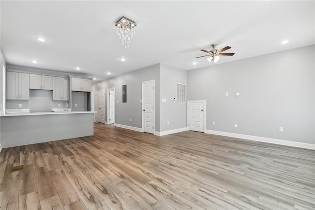 2830-32 Spain St, New Orleans, LA 70122 - unfurnished living room featuring a ceiling fan, light wood finished floors, and recessed lighting