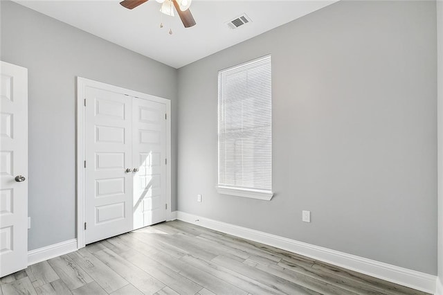 2830-32 Spain St, New Orleans, LA 70122 - unfurnished bedroom featuring light wood-style flooring, a ceiling fan, multiple windows, and a closet