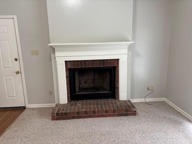 138 Woodland Ridge Dr, Mccomb, MS 39648 - detailed view of a brick fireplace, carpet, and baseboards