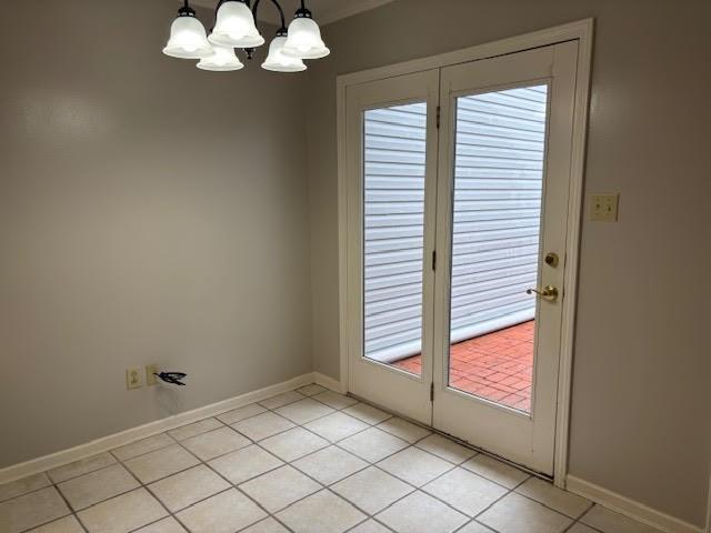 138 Woodland Ridge Dr, Mccomb, MS 39648 - doorway to outside with light tile patterned flooring, a chandelier, and baseboards
