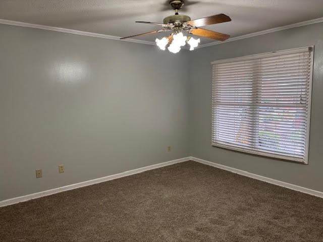 138 Woodland Ridge Dr, Mccomb, MS 39648 - empty room with crown molding, ceiling fan, dark colored carpet, and baseboards