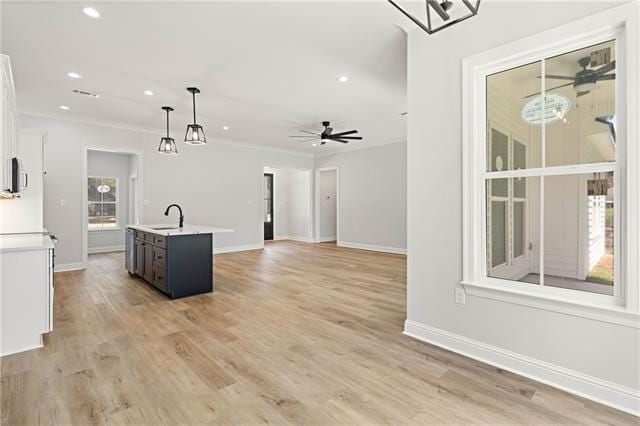14321 Lake Tahoe Dr, Covington, LA 70433 - kitchen featuring light countertops, recessed lighting, ceiling fan, pendant lighting, and a center island with sink