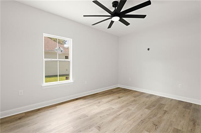 14321 Lake Tahoe Dr, Covington, LA 70433 - unfurnished room featuring light wood-style flooring, ceiling fan, and baseboards