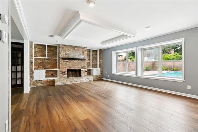 3501 Pin Oak Ave, New Orleans, LA 70131 - unfurnished living room with healthy amount of natural light, wood finished floors, baseboards, and a brick fireplace
