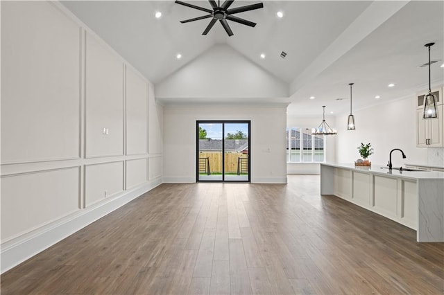 2104 Mississippi Ave, Metairie, LA 70003 - unfurnished living room with a sink, ceiling fan, recessed lighting, a chandelier, and wood finished floors