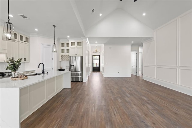 2104 Mississippi Ave, Metairie, LA 70003 - kitchen with appliances with stainless steel finishes, a sink, a center island with sink, light countertops, and dark wood-type flooring
