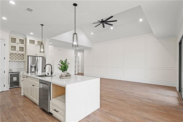 2104 Mississippi Ave, Metairie, LA 70003 - kitchen with stainless steel appliances, a decorative wall, wine cooler, open floor plan, and ceiling fan