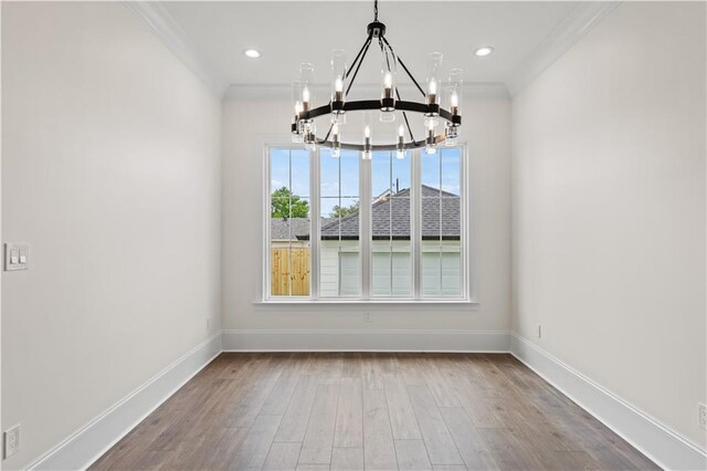2104 Mississippi Ave, Metairie, LA 70003 - unfurnished dining area featuring a chandelier, baseboards, wood finished floors, crown molding, and recessed lighting